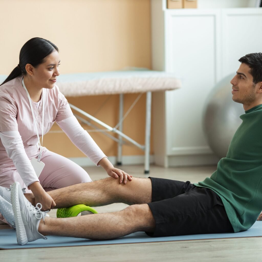 Physiotherapist helping senior citizen with exercises at home in Dubai